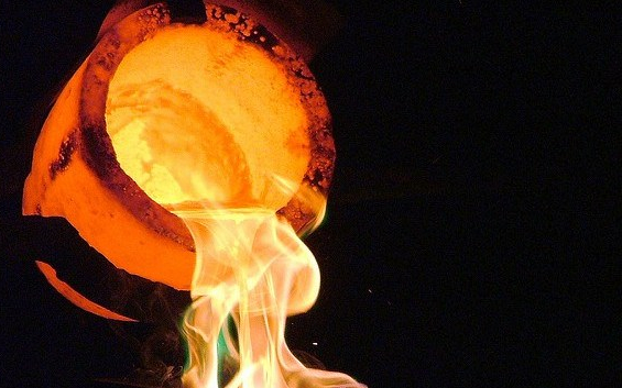 Pouring liquid gold from a crucible
